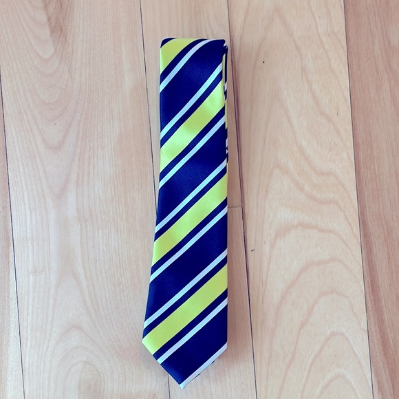 A yellow, blue, and white striped kids sized tie. - Picture 1 of 1